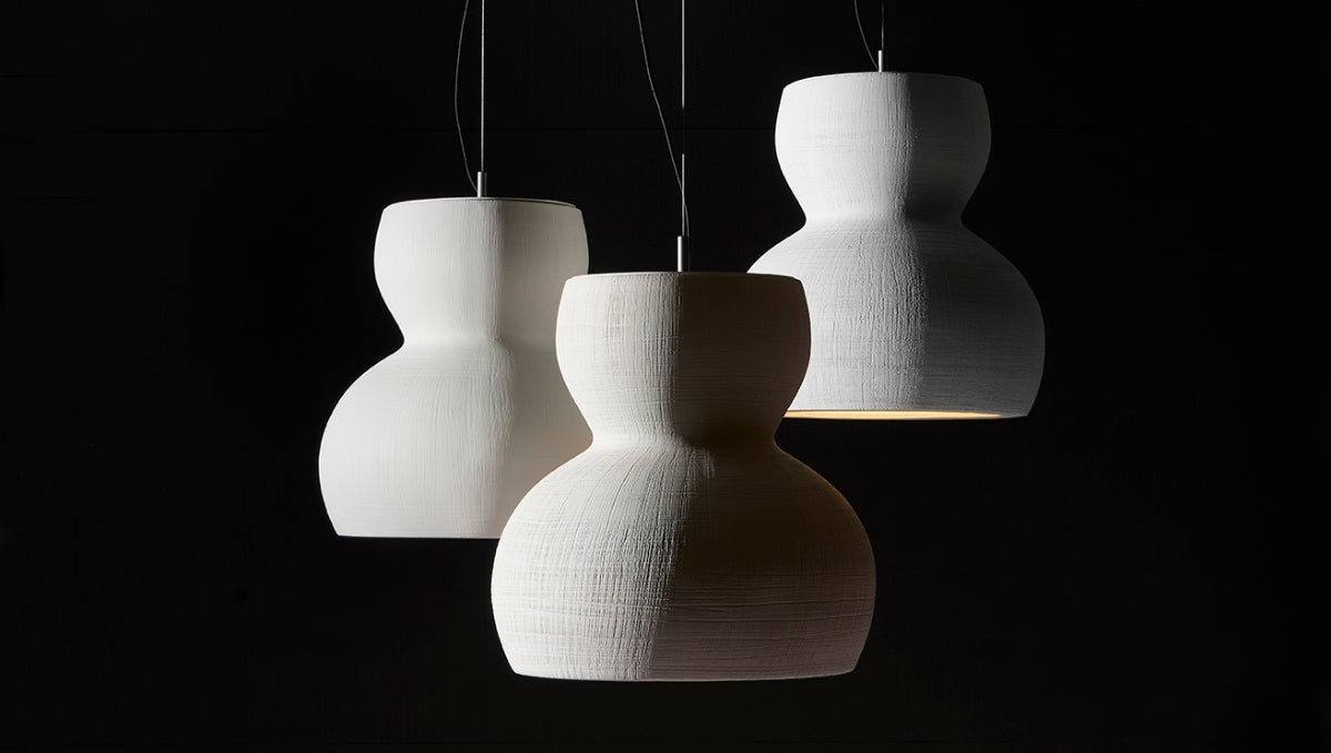 Handmade sculptural ceramic pendant lights with textured white finish, creating soft modern ambient illumination.