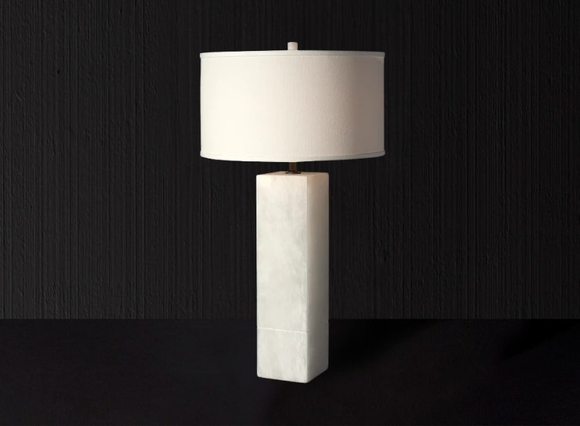 Contemporary Italian table lamp with sleek marble base and white drum shade for elegant ambient lighting.
