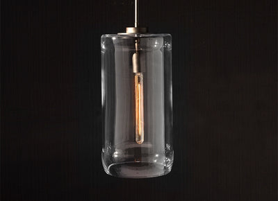 Minimalist Italian glass cylinder pendant light with exposed filament, offering warm modern ambient illumination.