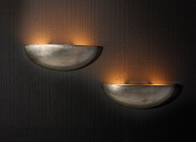 Contemporary wall sconces casting soft ambient light on textured walls