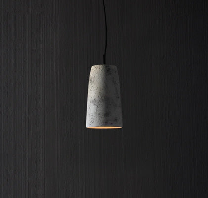 Italian stone pendant light with tapered form and warm downward ambient glow