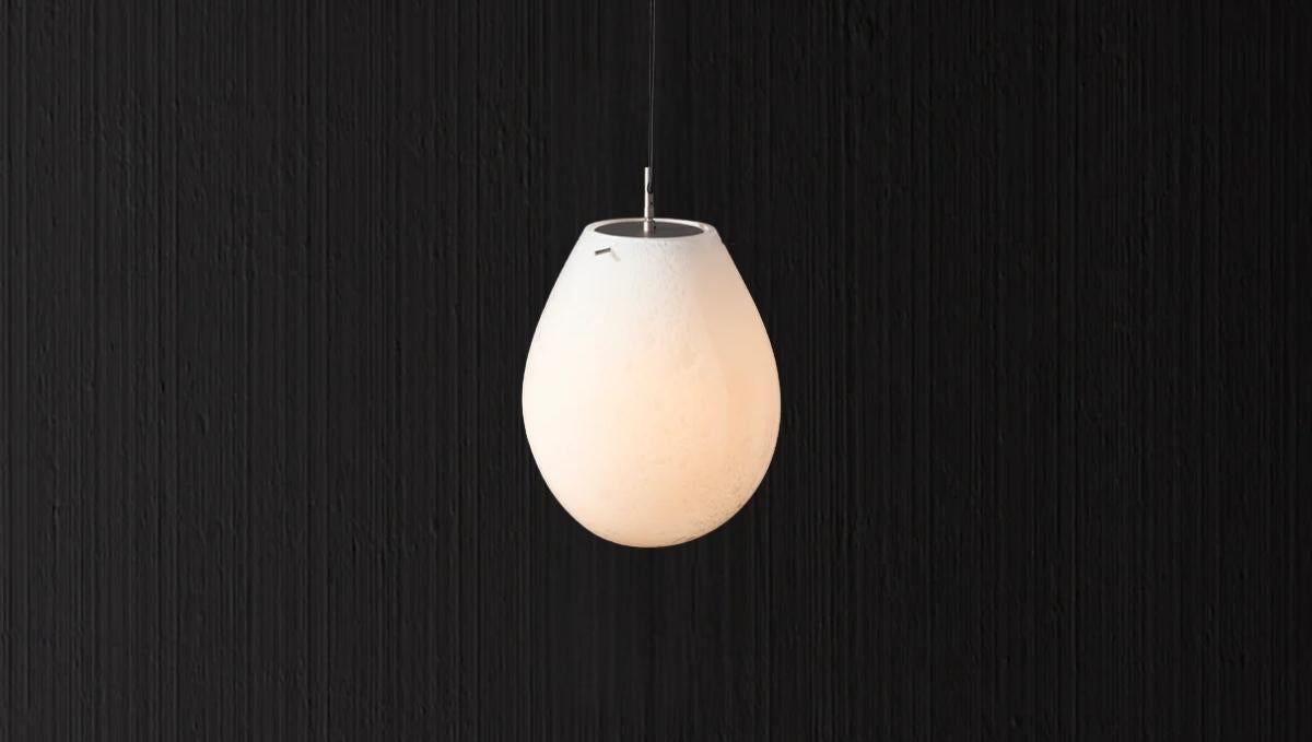 Italian teardrop glass pendant light with frosted finish and warm ambient glow