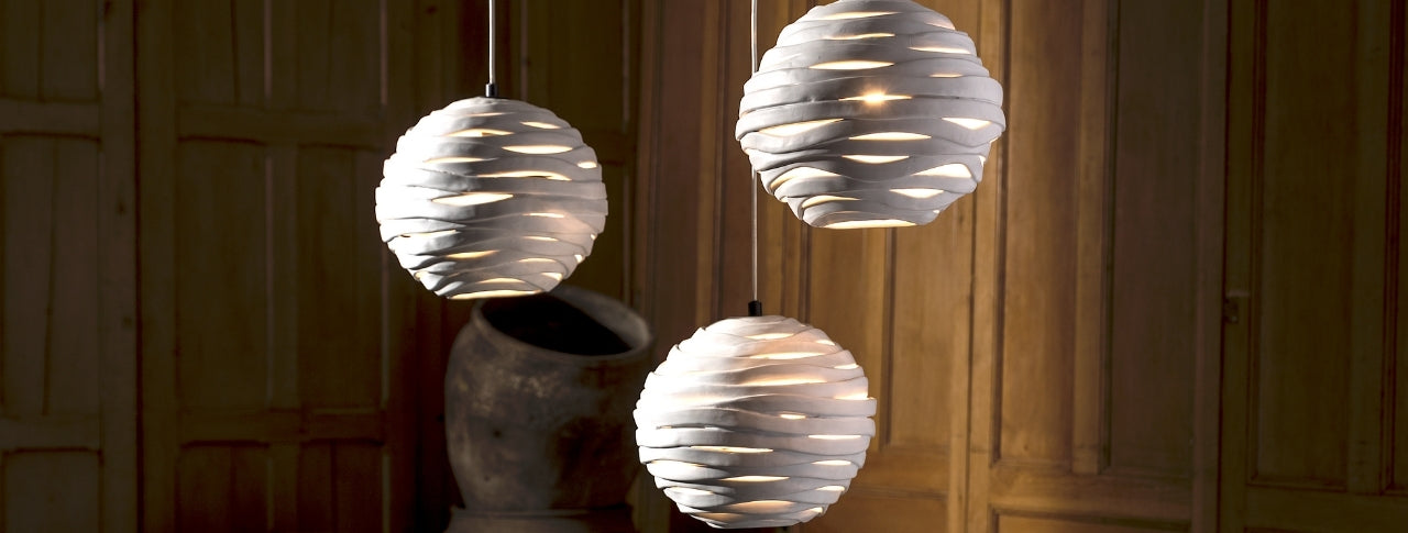 Hanging sculptural pendant lights creating warm ambiance in a luxury interior