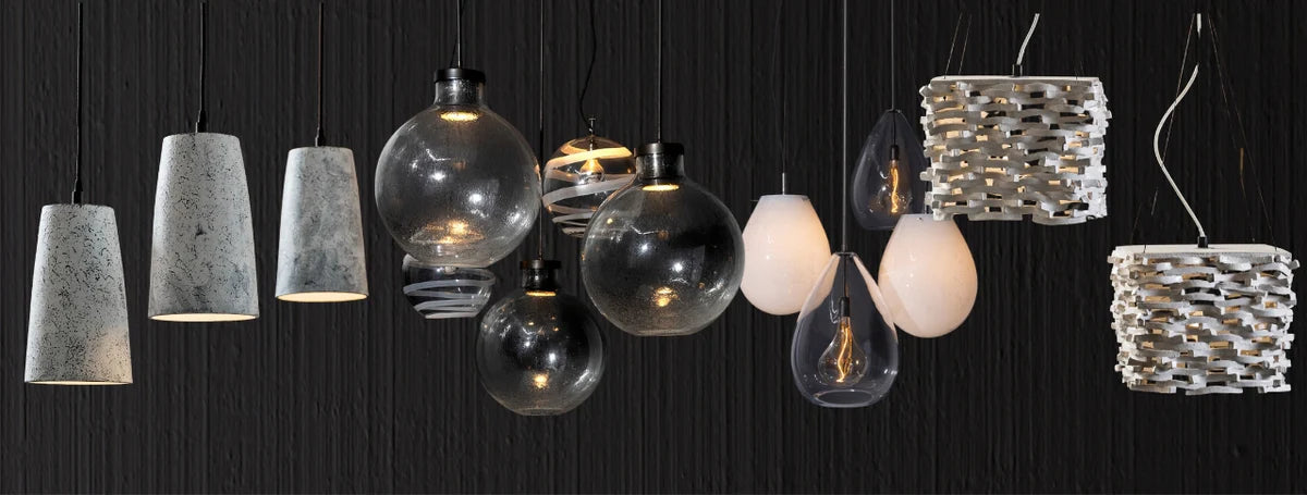 Assorted handcrafted pendant lights displayed in an artisan lighting collection
