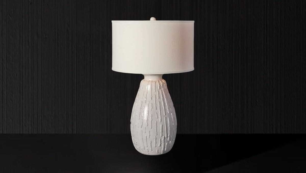 Artisan Lighting Company's white table lamp features a sleek design with a coordinating white shade for a clean look.
