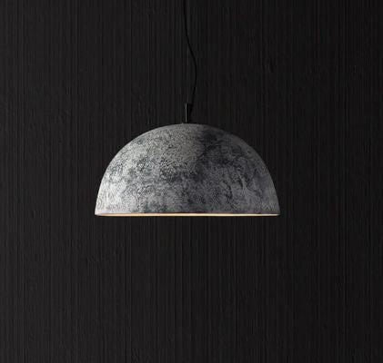 Artistic pendant light with a textured dome shade and warm downward glow