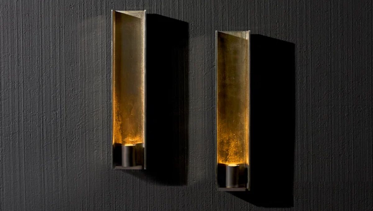 Handcrafted artistic wall sconces with warm amber light and sculptural bronze finish