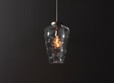 Artistic crystal pendant light with a sculptural glass shade and warm glowing bulb