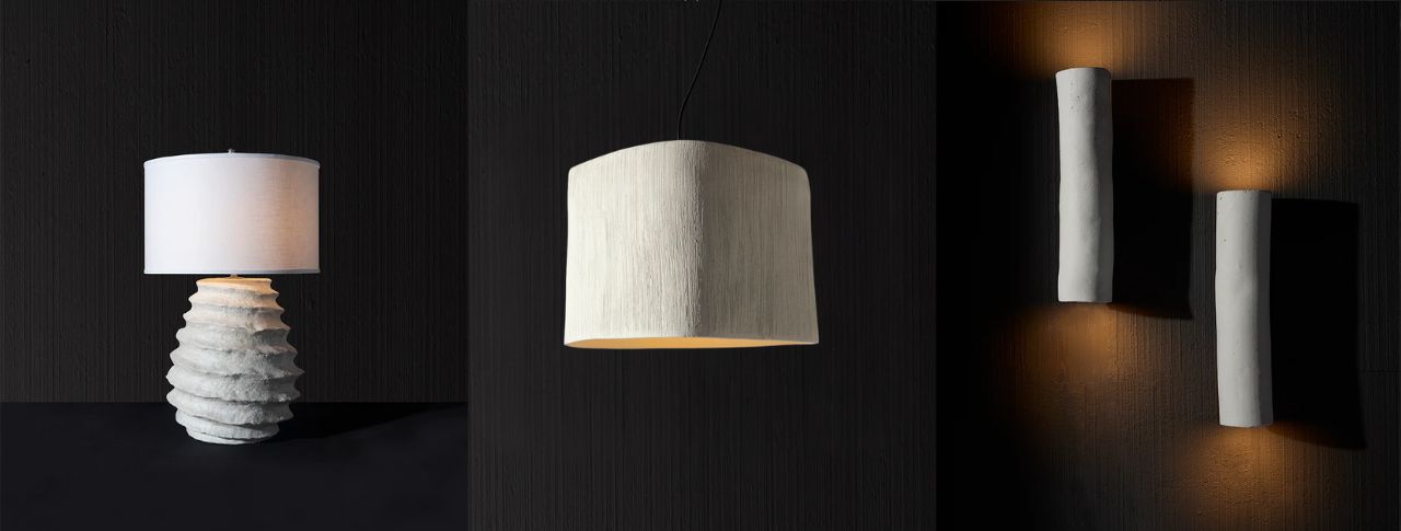 Artistic light fixtures featuring a table lamp, pendant, and sculptural wall sconces
