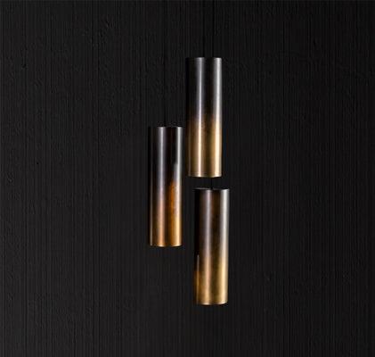 Three cylindrical metal pendant lights showcasing a sleek modern bespoke lighting design.
