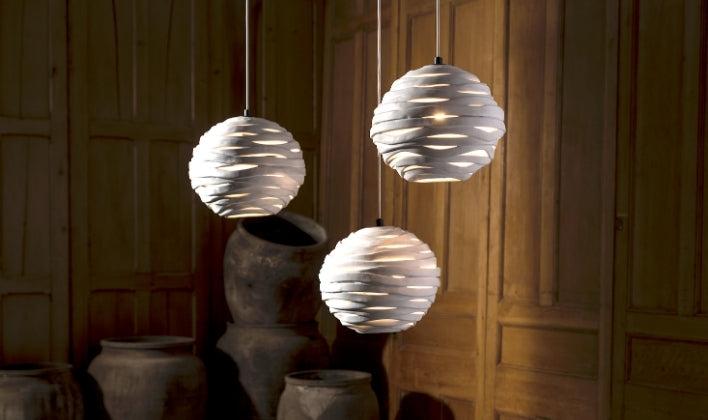 Sculptural pendant lights creating warm ambient lighting in a curated interior
