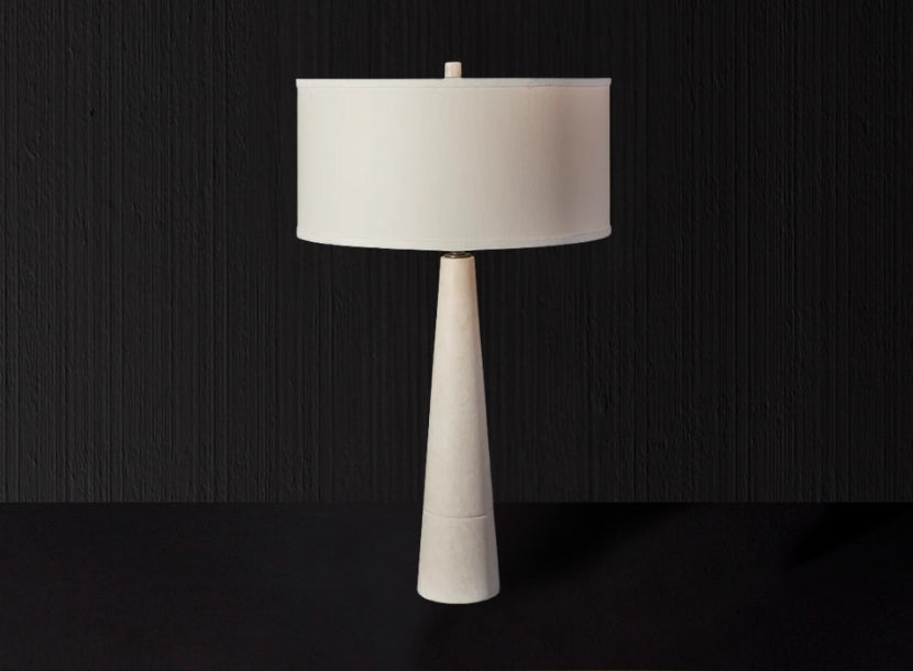 Elegant sculptural table lamp with tapered base and white drum shade, ideal for statement luxury home interiors.