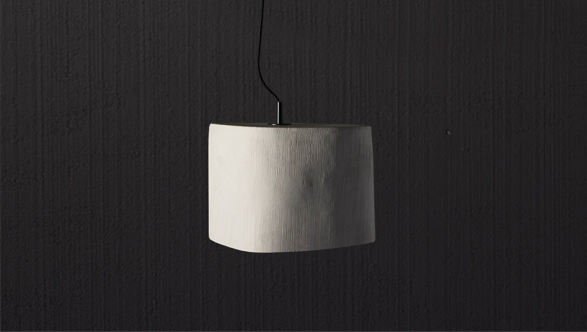 Minimalist sculptural pendant light with textured white finish, designed as a refined statement piece for luxury homes.