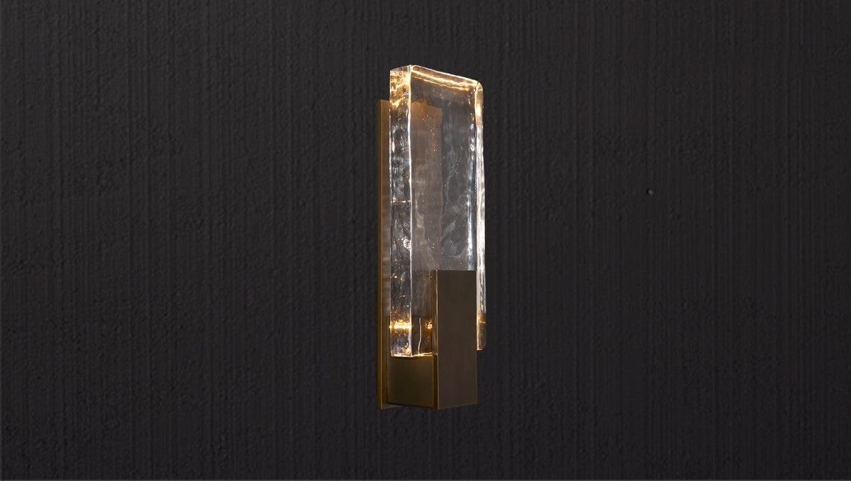 Statement wall light with sculpted glass and warm glow in a luxury interior