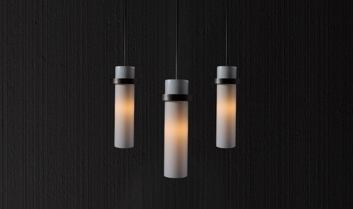 Modern cylindrical pendant lights with soft glow for sleek interior lighting by RENGCO