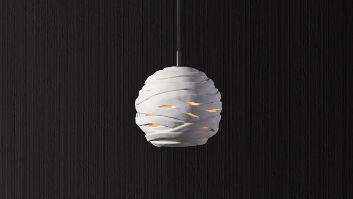 Modern sculptural pendant light with layered design and warm glow for interiors by RENGCO